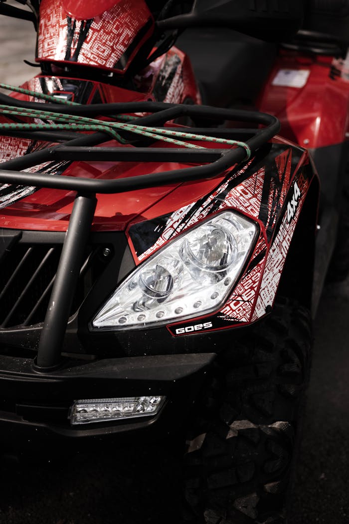 gallery-2 Detailed view of a red offroad ATV with modern design and graphic details.